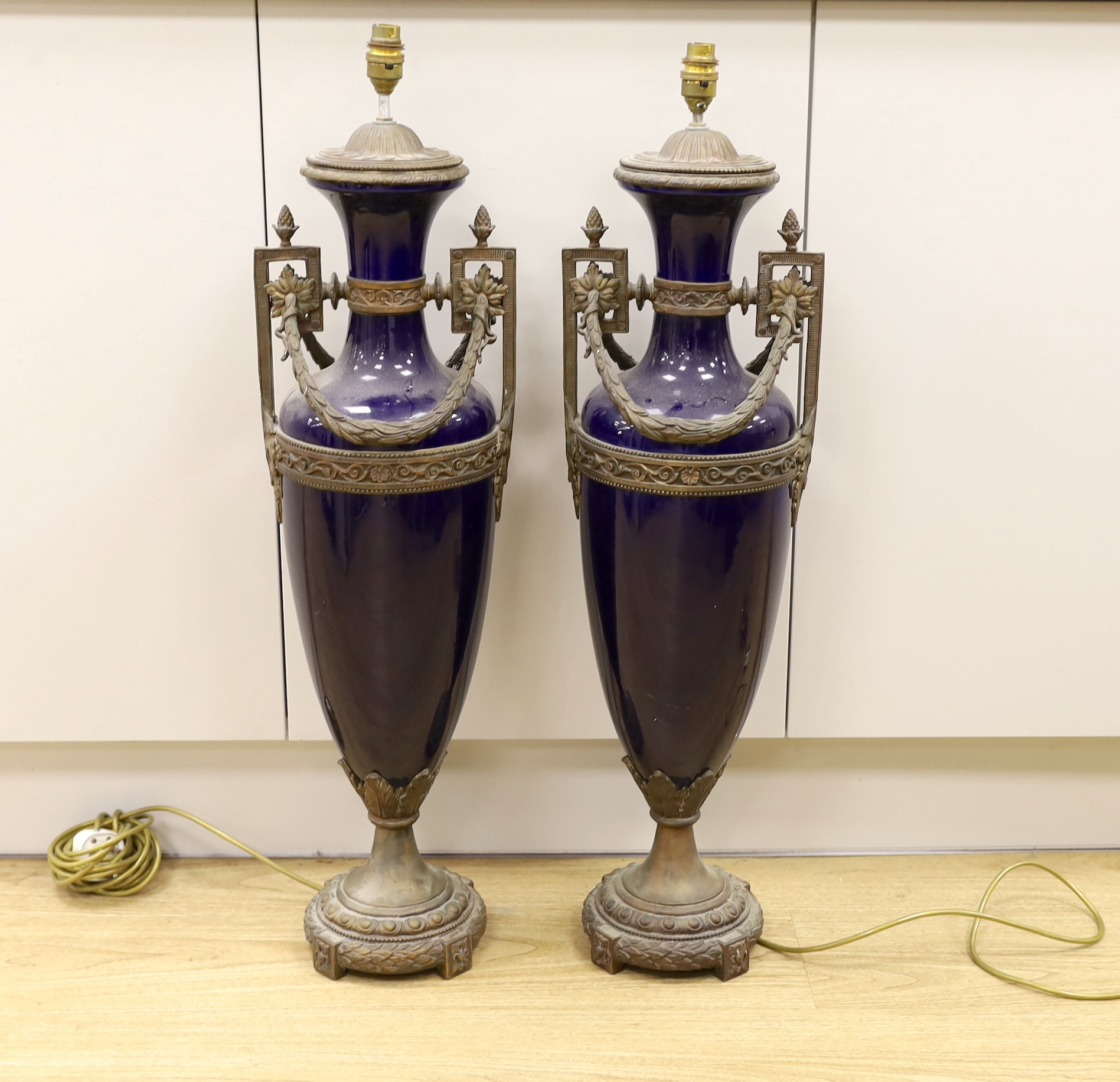 A pair of large Sevres style cobalt blue glazed ceramic lamps with bronzed mounts, 84cm total height